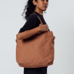 Female model carrying biscuit canvas Buoy tote bag on shoulder | KlippiK Middle East