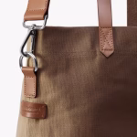 Close up of biscuit Buoy tote leather handles and silver clip hardware | KlippiK Middle East