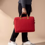Lifestyle view of crimson red Fleet messenger bag with leather handles | KlippiK Kuwait