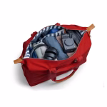 Crimson red Field duffle filled with travel clothes and accessories | KlippiK Kuwait