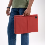 Lifestyle shot of coral red Pivot laptop sleeve large | KlippiK Kuwait