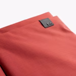 Close up of coral red ripstop sleeve logo label and fabric weave | KlippiK Kuwait