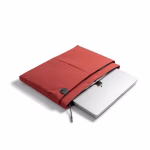 Angled view of MacBook sliding out of coral red laptop sleeve | KlippiK Kuwait