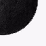 Close-up of round black leather DailyObjects mouse pad edge and vegan leather texture — desk accessory Middle East