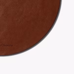 Close-up of round brown leather DailyObjects mouse pad edge and vegan leather texture — desk accessory UAE