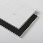 Roda Week Pad angled to show the rigid black backing board beneath the sheets