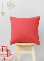 Cherry Red Cushion Cover - Red by Yellow Dwelling, styled on a light wood stool against a pale wall
