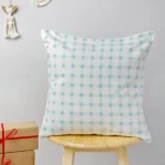 Ice Blue Gingham Cushion Cover by Yellow Dwelling, styled on a light wood stool against a pale wall