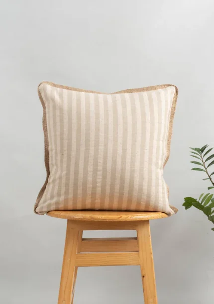 Loom Linen Minimal Design Cushion Cover for Sofa - Beige by Yellow Dwelling, styled on a light wood stool against a pale wall