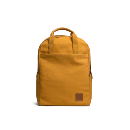 Mustard Field Daypack — canvas daypack with a top handle and leather logo patch, shown on white