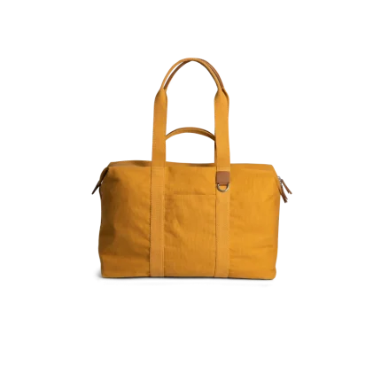 Mustard Field Duffle Bag — canvas duffle with leather trim and twin handles, shown on white