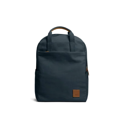Navy Field Daypack — canvas daypack with a top handle and leather logo patch, shown on white