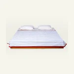 Dreamy Blue with Candy Red Muted Layers Dohar shown made up on a low wooden platform bed with two matching pillows