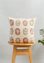 Stamps Embroidered Floral Motif 100% Cotton Cushion Cover for Sofa - Green and Rust by Yellow Dwelling, styled on a light wood stool against a pale wall