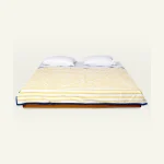 Mellow Yellow with Misty Blue Muted Layers Dohar shown made up on a low wooden platform bed with two matching pillows