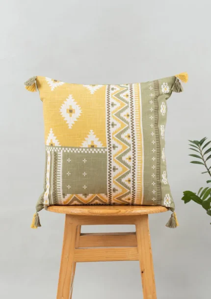 Zenith 100% cotton Printed Geometric Cushion Cover with Tassel for Sofa - Yellow by Yellow Dwelling, styled on a light wood stool against a pale wall