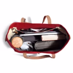 Top down view of crimson red Buoy tote holding book laptop and mug | KlippiK Worldwide