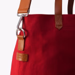 Close up of crimson red Buoy tote leather handles and clip hardware | KlippiK Worldwide
