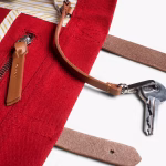 Side detail of crimson red canvas tote with keys clipped to leather loop | KlippiK Worldwide
