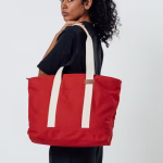 Model carrying crimson red Field tote bag on shoulder | KlippiK Worldwide