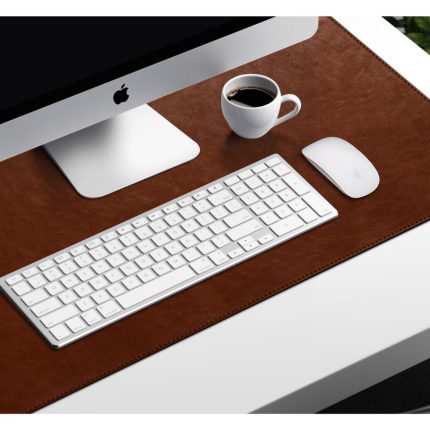 Turf Vegan Leather Desk Mat in tan set up with an iMac, keyboard, mouse and a coffee cup