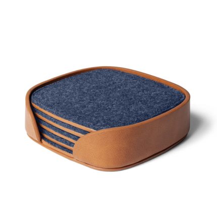 Squircle Felt Coaster Set Blue with blue felt face and vegan leather holding tray on desk
