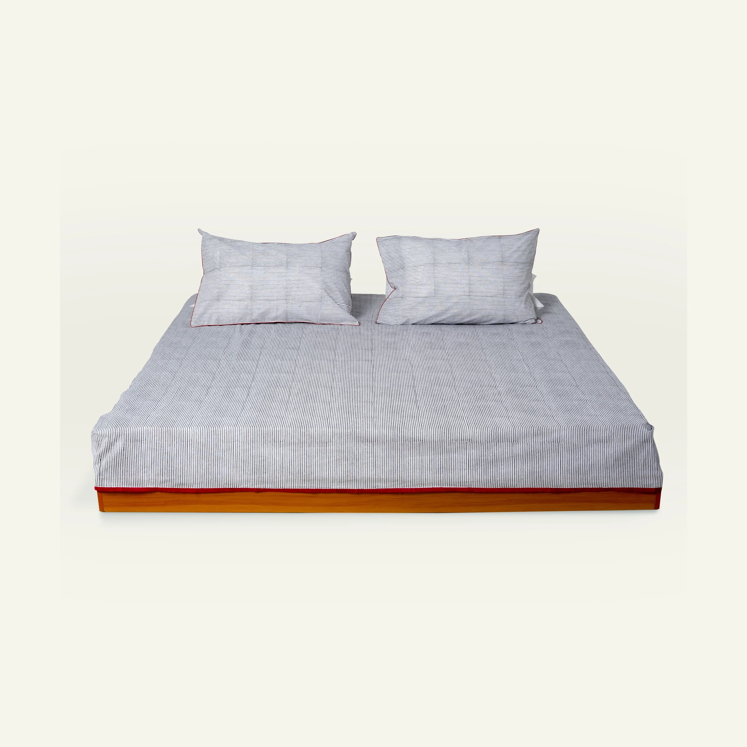 Black Red Pure stripes 1 copy Cloudy Black with Candy Red Pure Stripes Flat Bedsheet shown made up on a low wooden platform bed with two matching pillows