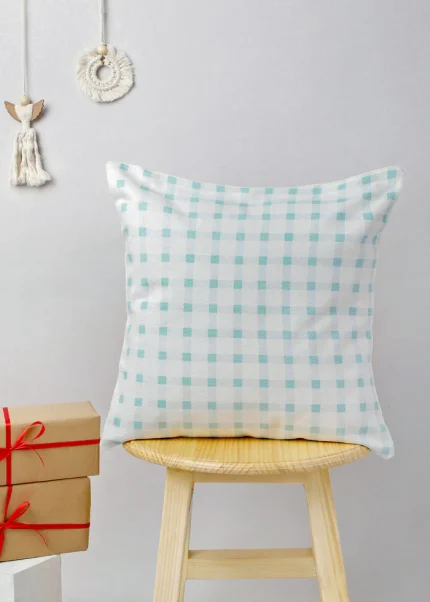Ice Blue Gingham Cushion Cover by Yellow Dwelling, styled on a light wood stool against a pale wall