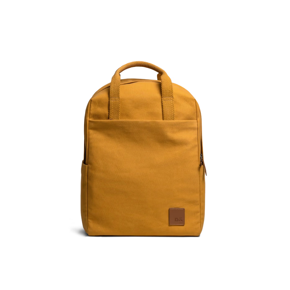 Mustard-Field-Daypack-vw Mustard Field Daypack — canvas daypack with a top handle and leather logo patch, shown on white