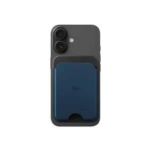 Navy Blue-Grey Leather MagSafe Card Wallet attached to the back of a black iPhone, shown on white