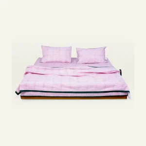 Berry Pink with Pearl Green Pure Stripes bed linen shown made up on a low wooden platform bed with two matching pillows