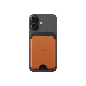 Tan-Grey Leather MagSafe Card Wallet attached to the back of a black iPhone, shown on white