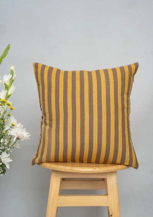 20230831-DSC00803-Edit Sand Dunes 100% Cotton Geometric Cushion Cover For Sofa - Mustard and Brown by Yellow Dwelling, styled on a light wood stool against a pale wall