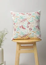Birds Paradise Cushion Cover by Yellow Dwelling, styled on a light wood stool against a pale wall