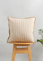 Loom Linen Minimal Design Cushion Cover for Sofa - Beige by Yellow Dwelling, styled on a light wood stool against a pale wall