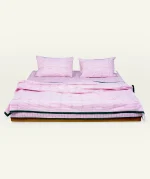 Berry Pink with Pearl Green Pure Stripes Dohar shown made up on a low wooden platform bed with two matching pillows