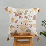Waltz Printed Floral Pattern 100% Cotton Cushion Cover for Sofa with Tassels - Multicolor by Yellow Dwelling, styled on a light wood stool against a pale wall
