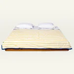 Mellow Yellow with Misty Blue Muted Layers Dohar shown made up on a low wooden platform bed with two matching pillows