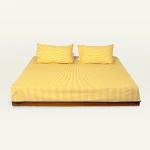 Mellow Yellow with Misty Blue Silent Stripes Flat Bedsheet shown made up on a low wooden platform bed with two matching pillows