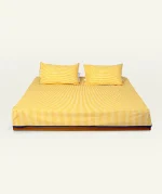 Mellow Yellow with Misty Blue Silent Stripes Flat Bedsheet shown made up on a low wooden platform bed with two matching pillows