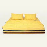 Mellow Yellow with Misty Blue Silent Stripes Dohar shown made up on a low wooden platform bed with two matching pillows