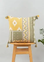 Zenith 100% cotton Printed Geometric Cushion Cover with Tassel for Sofa - Yellow by Yellow Dwelling, styled on a light wood stool against a pale wall