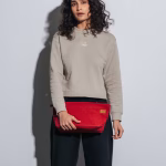 Model carrying crimson red canvas Jumbo Taxi Organiser pouch | KlippiK Kuwait