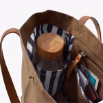 Interior view of biscuit Buoy tote with striped lining bottle and items | KlippiK Kuwait