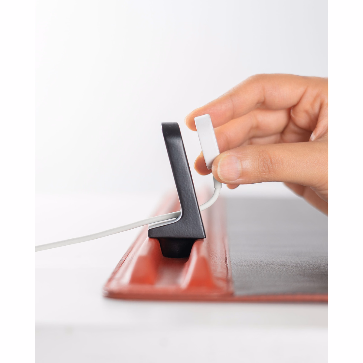 Red-Black Snap On Organiser Desk Mat with Cable Holder + Phone Mount + Apple Watch Charging Stand in Black – Close-up Red-Black Snap On Organiser Desk Mat with Cable Holder + Phone Mount + Apple Watch Charging Stand in Black – Close-up Mat with Tech Accessories | KlippiK with Tech Accessories | KlippiK