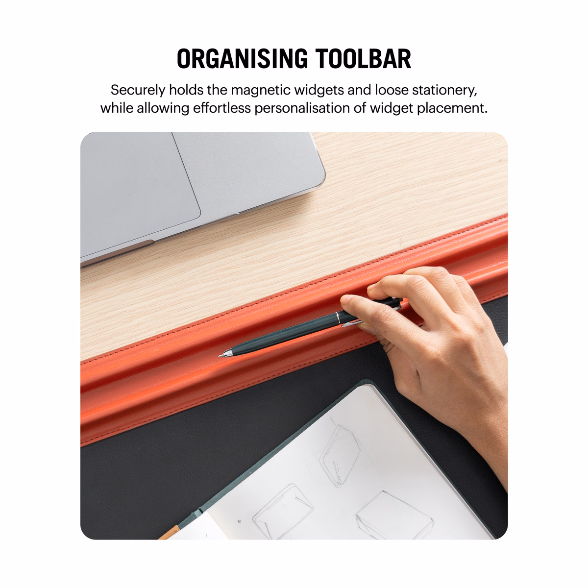 Red-Black Snap On Organiser Desk Mat with Cable Holder + Phone Mount + Apple Watch Charging Stand in Black – Close up view of hand placing pen on the deskmat compartment | KlippiK