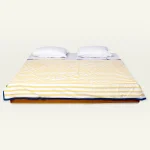 Mellow Yellow with Misty Blue Muted Layers Dohar shown made up on a low wooden platform bed with two matching pillows