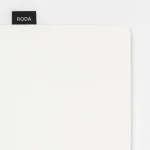Corner detail of the Roda Notepad's dot grid page and branded tab