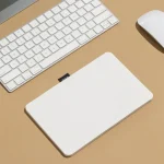 Roda Notepad on a wood desk beside a keyboard and mouse
