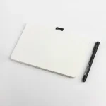 Roda Notepad lying flat with a black pen alongside it